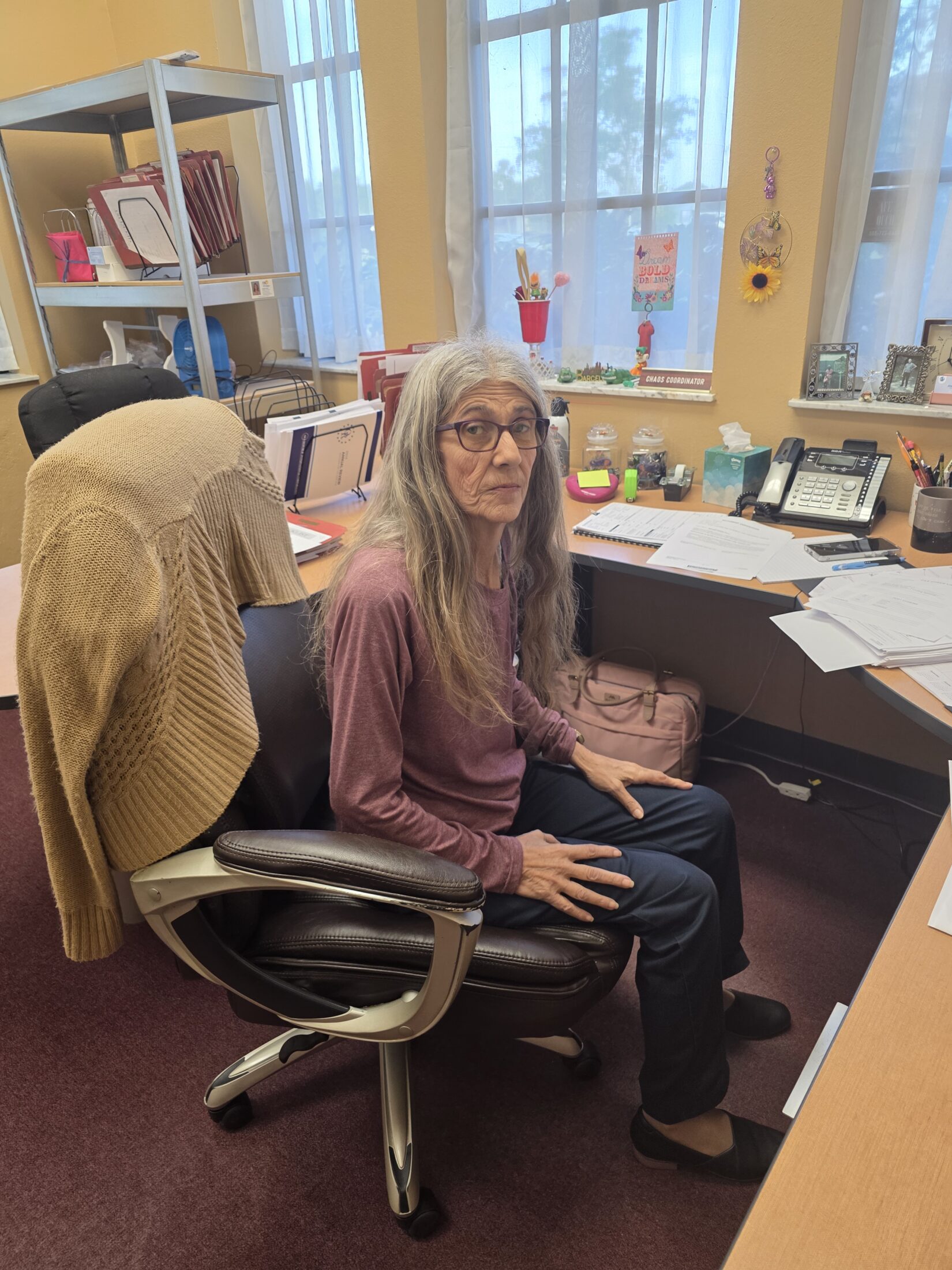 Ann Edwards sitting at her desk